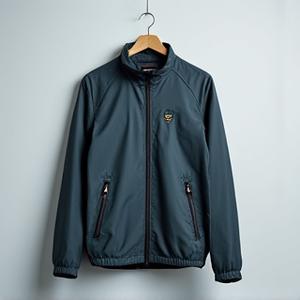 Stylish fishing jacket made from recycled plastic bottles, hanging on a hanger.